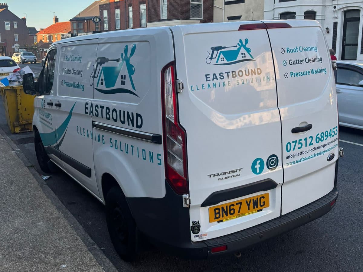 The rear of the Eastbound van showing the logo, the services offered and the phone number